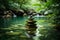 Zen stones pyramid on water surface, greenery