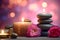 Zen stones, roses flowers and aromatic candles spa arrangement on wooden table