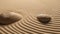 zen stones in sand with ripples in the background, closeup of photo