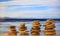 Zen stones stacks on blue sky and sea background