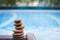 Zen stones on wooden banch on pool