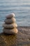 Zen style stones by the ocean. Tower of pebbles