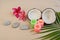 Zen tropical background with coconuts, plumeria flowers, rocks, and burning candles