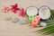 Zen tropical background with coconuts, plumeria flowers, rocks, and burning candles