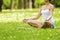 Zen yoga woman lotos position on the grass.