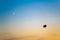 Zeppelin in evening sky with crescent moon. Airship in backlight in bright sky. Zeppelin in sky during sunset with crescent moon..