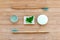 Zero waste bathroom basics. Bamboo toothbrushes,  solid toothpaste in metal tin, solid shampoo and soap on wood background