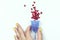 Zero Waste Concept Female Hand are Holding Blue Menstrual Cup Women Health Concept Blue Menstrual Cup with Pomegranate Seeds