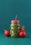 Zero waste concept. Green fruit smoothie on blue background in glass santa claus jar Healthy and diet food concept