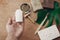 Zero waste concept. Hand holding natural eco crystal deodorant on background of bamboo toothbrush, soap, solid shampoo, metal