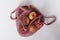Zero waste concept. Red and yellow apples in pink textile bag.