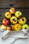 Zero waste concept. Red and yellow ugly apples in white textile bag on wooden background.