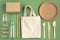 Zero Waste Cotton Bag. Zero waste concept. Textile eco bag, glass jars, wooden kitchen accessories on green background.