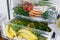 Zero waste grocery in fridge. Fresh vegetables in opened drawer in refrigerator. Plastic free carrots,tomatoes, mushrooms,bananas,