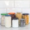 Zero waste plastic-free concept at home, different food in reused glass jars on the kitchen, copy space, square