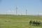 Zhambyl region, Kazakhstan - 05.15.2013 : Wind turbines located in an open hilly area with trees and grass