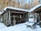 Zheludyevo, Vladimir region, Russia, January, 17, 2021.Wooden outbuildings with exhibits of the ethnographic park-museum `Russian