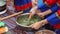 A Zhuang woman is making Chinese Guangxi Zhuang specialties, wormwood cake