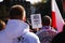 Zielona Gora, Poland - October 3, 2015: People gathered at a rally organized by right-wing groups hold a Polish flag and a banner