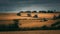 A zig zag patern of hedges around cereal fields under a very stormy sky.