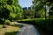 Zigzag shady path to modern building in sunny summer