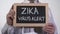 Zika virus alert written on blackboard in therapist hands, infectious disease