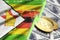 Zimbabwe flag and cryptocurrency growing trend with two bitcoins on dollar bills