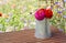 Zinnias in a rustic pitcher on a garden table