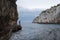 Zinzulusa Caves, near Castro on the Salento Peninsula in Puglia, Italy. Person stands on gang plank at entrance to the caves.