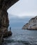 Zinzulusa Caves, near Castro on the Salento Peninsula in Puglia, Italy. Person stands on gang plank at entrance to the caves.