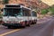 A Zion National Park shuttle bus drives along the road inside the National Park. The shuttle