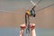 Zipline. Equipment for safe sliding on steel cable. Woman`s hands close-up during the flight