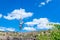 Zipline. A view of a child sliding on a steel cable against a beautiful blue sky with clouds. Extreme and active rest.