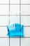 ziplock plastic bag with blue water hanging on tile wall, earth