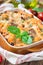 Ziti bolognese in baking dish. Pasta casserole with minced meat, tomato sauce and cheese, vertical