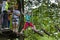 Zloty Potok, Poland - July 23, 2016: Visitors in adventure park clambering with ropes wear protective helmets.