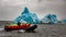 Zodiac boat approaching amazingly blue iceberg