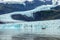 Zodiac boat among icebergs in Fjallsarlon glacier lagoon, arctic landscape Iceland