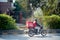 Zomato delivery boy with red hot box for food on a bike zooming at high speed to deliver orders for the upcoming