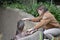 Zookeeper inspects hippo\'s mouth teeth