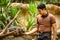 Zookeeper at Singapore Zoo haZookeeper at Singapore Zoo holds a Turkey Vulturend feeds a lizard