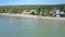 Zoom across Ocean to Green Coastline Boats Sail Upper View