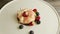 Zoom in at broken mousse creamy dessert with berries, mint, and bize