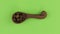 Zoom of a clay spoon with coffee bean. Chroma key, green screen.