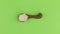 Zoom of a clay spoon with rice grain. Chroma key, green screen.