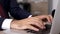 Zoom in dynamic shot close up businessman hands typing fast on laptop keyboard