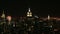 Zoom from empire state building to busy night skyline