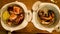 Zoom in footage on two plates with gourmet seafood