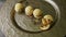 Zoom in at half eaten finely decorated four spherical sponge biscuits on golden plate