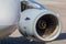 Zoom image of a turbine of a passenger jet at the airport.